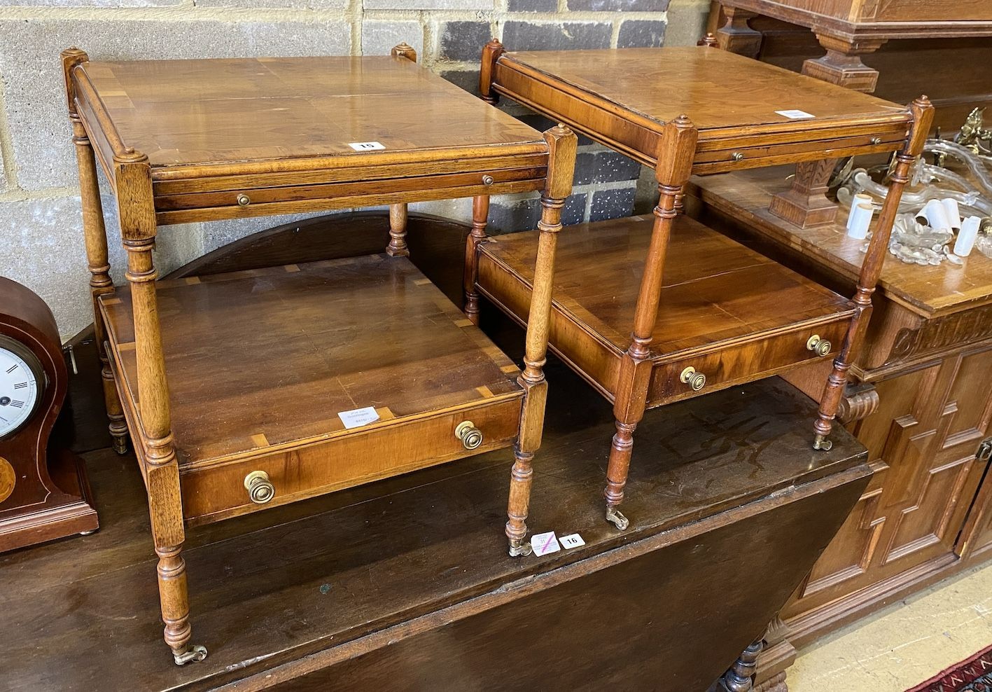 A pair of reproduction yew two tier side tables fitted slides, width 46cm, depth 46cm, height 58cm